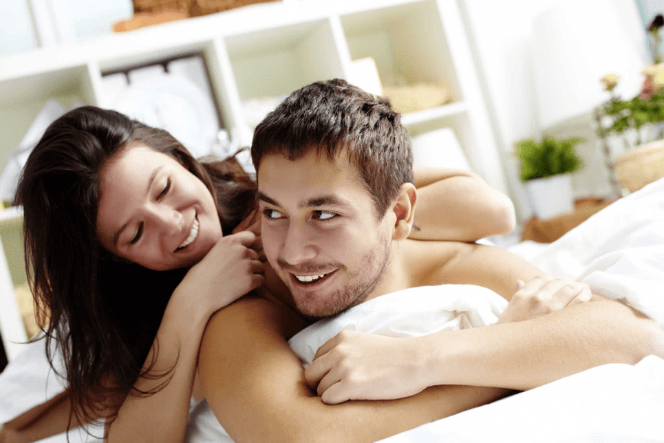 Woman in bed with a man who enlarges his dick with a nozzle